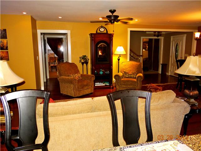 6040 Temple Road Nashville, TN 37221 - Photo 20 of 20 Great Room open floor plan view from island to formal living area with HearthSense vent free arched tower fireplace natural gas in cherry wood finish