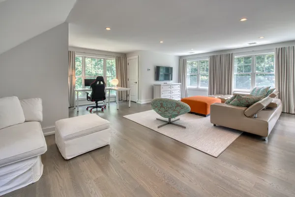 a living room with furniture and wooden floor