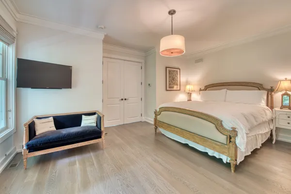 a bedroom with a bed and a flat screen tv