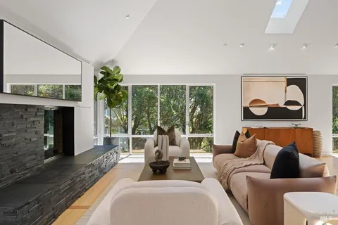 a large kitchen with stainless steel appliances a stove a sink dishwasher a microwave oven with cabinets and wooden floor