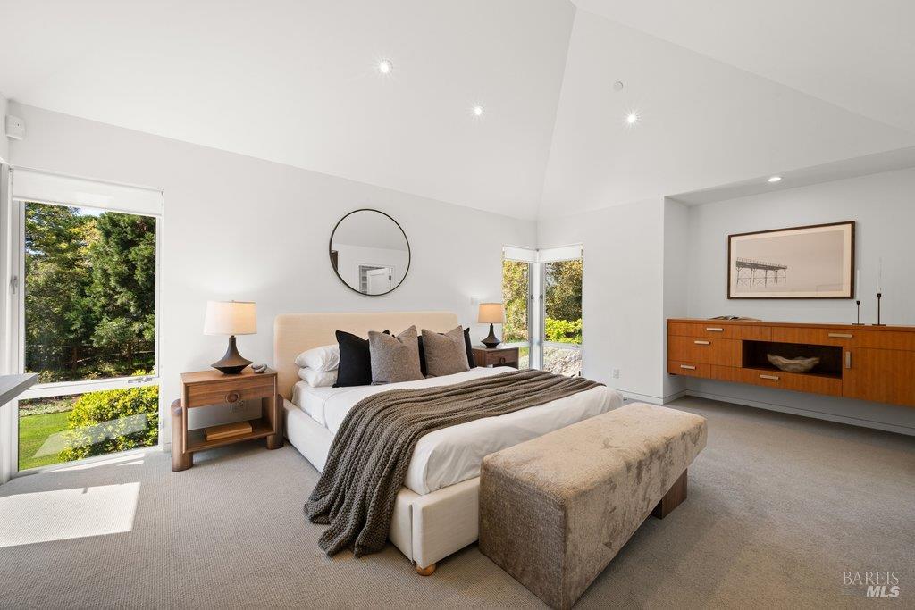 103 Reed Ranch Road Tiburon, CA 94920 - Photo 31 of 89 a bedroom with a bed and a chandelier
