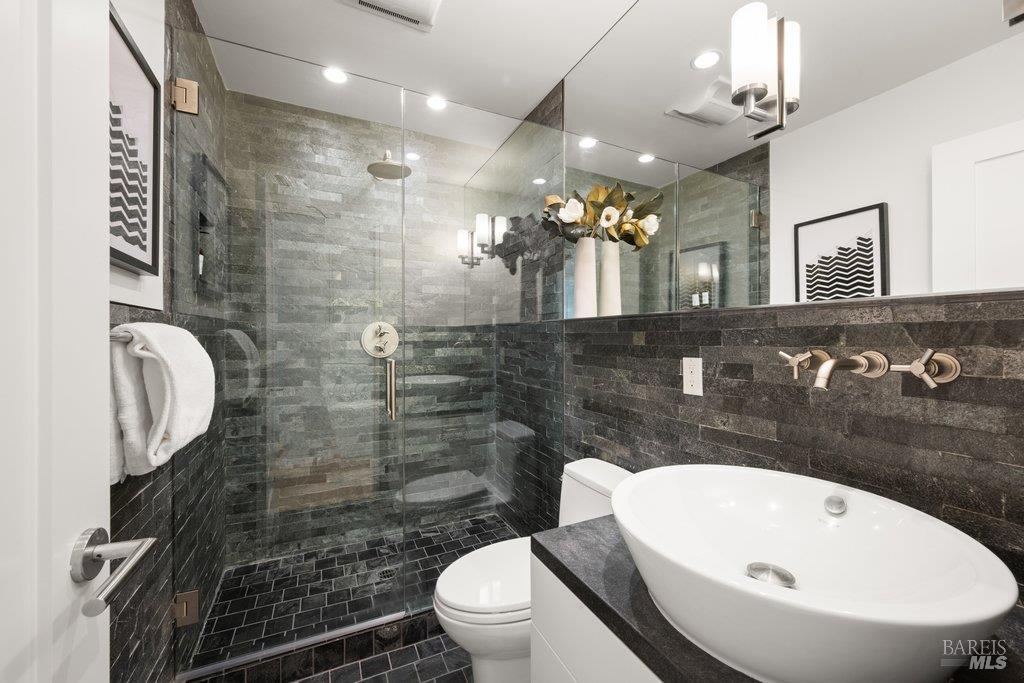 103 Reed Ranch Road Tiburon, CA 94920 - Photo 41 of 89 a bathroom with a sink a toilet and shower
