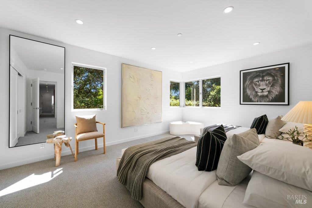 103 Reed Ranch Road Tiburon, CA 94920 - Photo 48 of 89 a bedroom with a bed and wooden floor