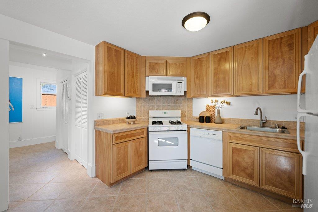103 Reed Ranch Road Tiburon, CA 94920 - Photo 59 of 89 a kitchen with a stove sink and cabinets
