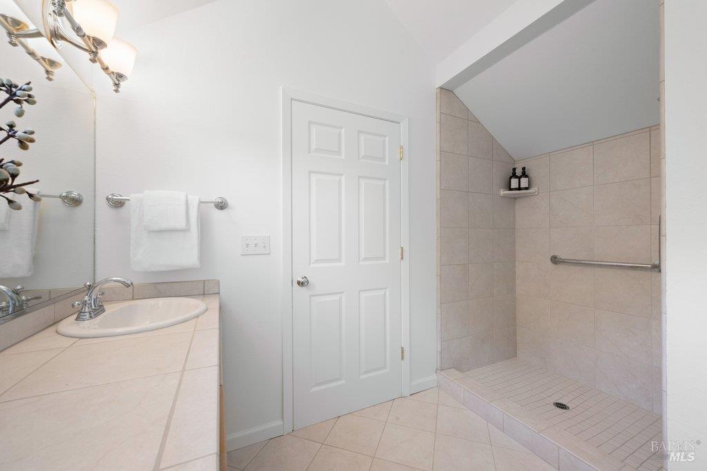 103 Reed Ranch Road Tiburon, CA 94920 - Photo 62 of 89 a bathroom with a shower a sink and a mirror