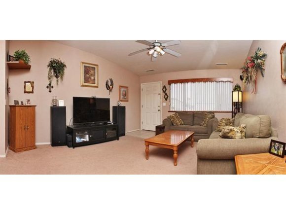 4336 North Sauter Drive East Prescott Valley, AZ 86314 - Photo 4 of 19 a living room with furniture a flat screen tv and a fireplace