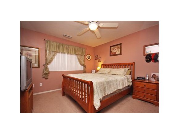 4336 North Sauter Drive East Prescott Valley, AZ 86314 - Photo 9 of 19 a bedroom with a bed window and a lamp