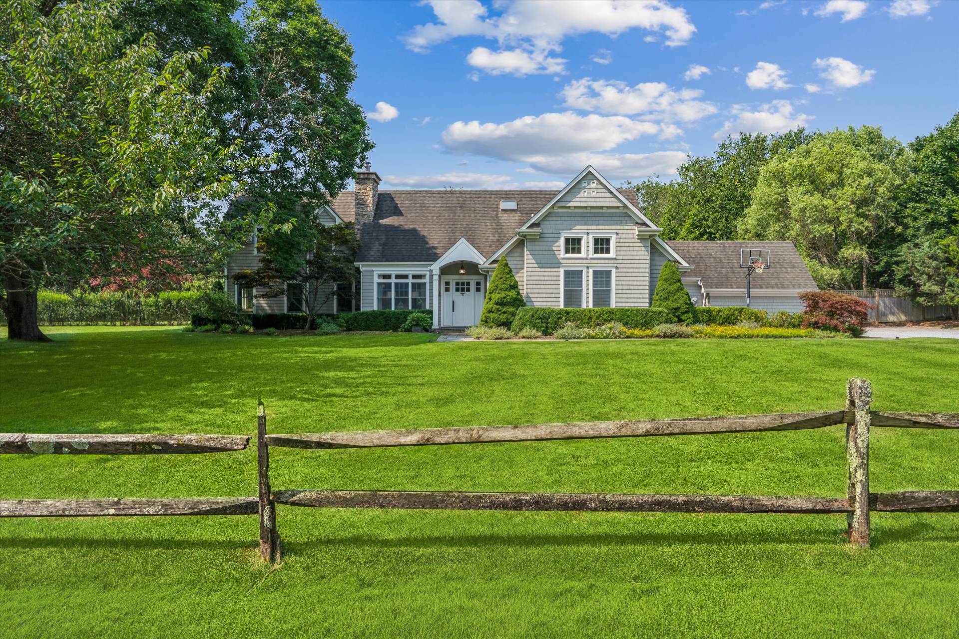 a view of a house with a big yard and potted plants