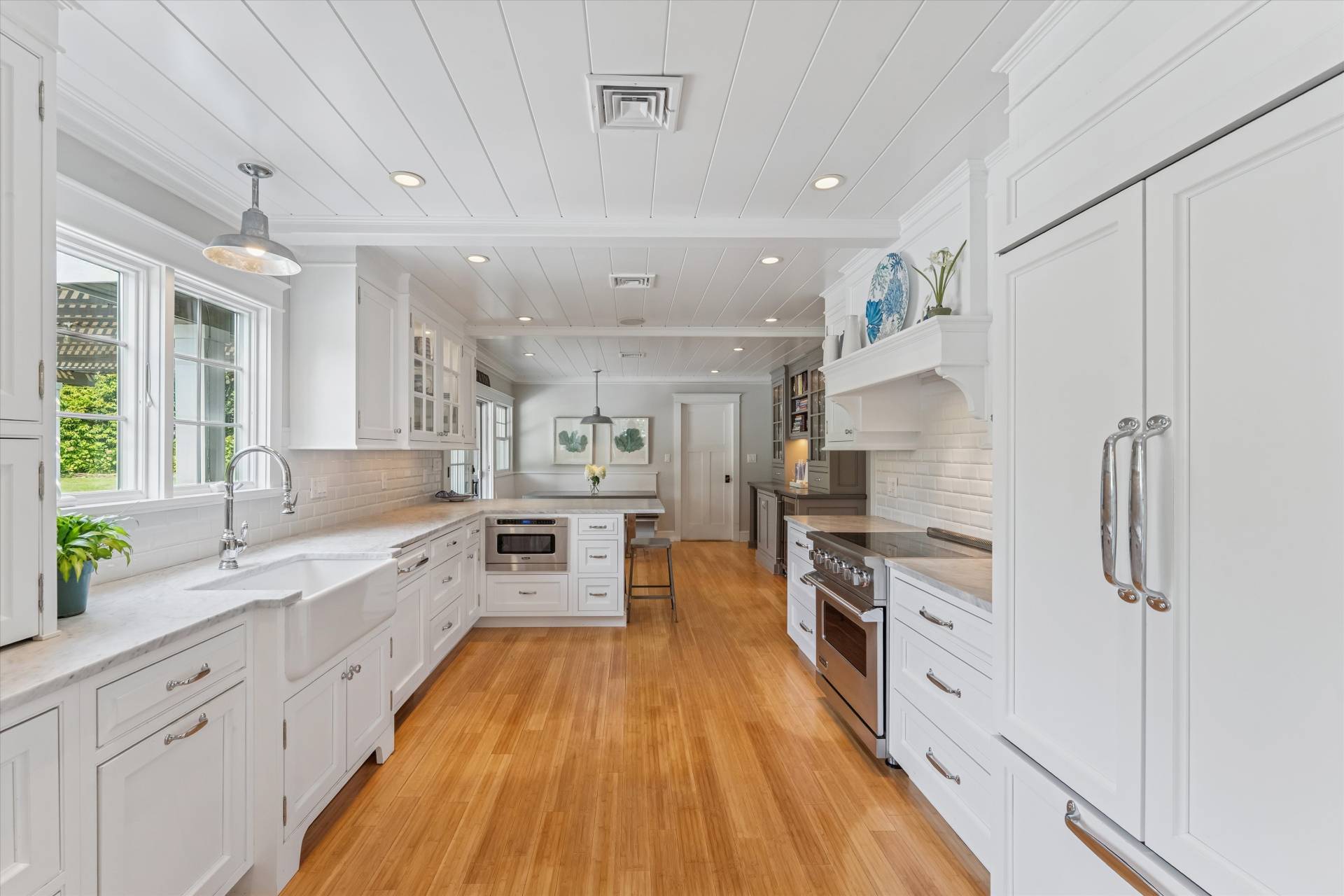 29 Bridle Path Remsenburg, NY 11960 - Photo 13 of 33 a large kitchen with stainless steel appliances lots of counter space and wooden floor