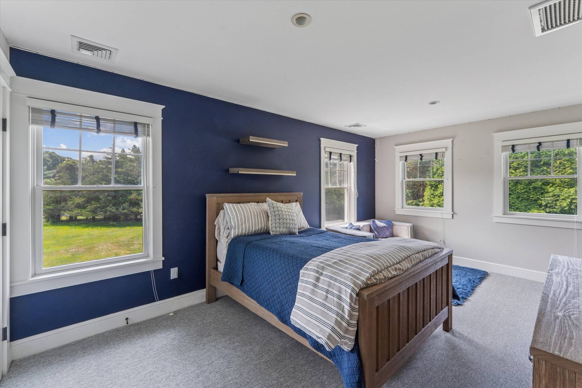 29 Bridle Path Remsenburg, NY 11960 - Photo 21 of 33 a bed sitting in a bedroom next to a window