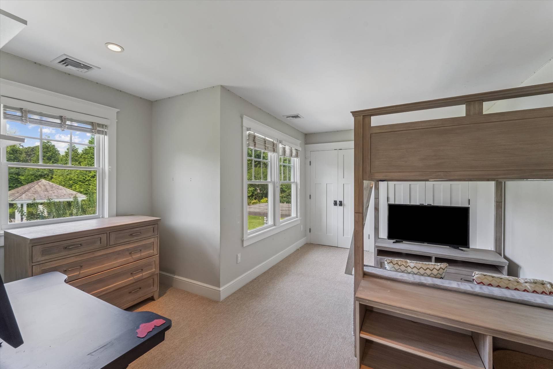29 Bridle Path Remsenburg, NY 11960 - Photo 22 of 33 a living room with a fireplace furniture a flat screen tv and a large window