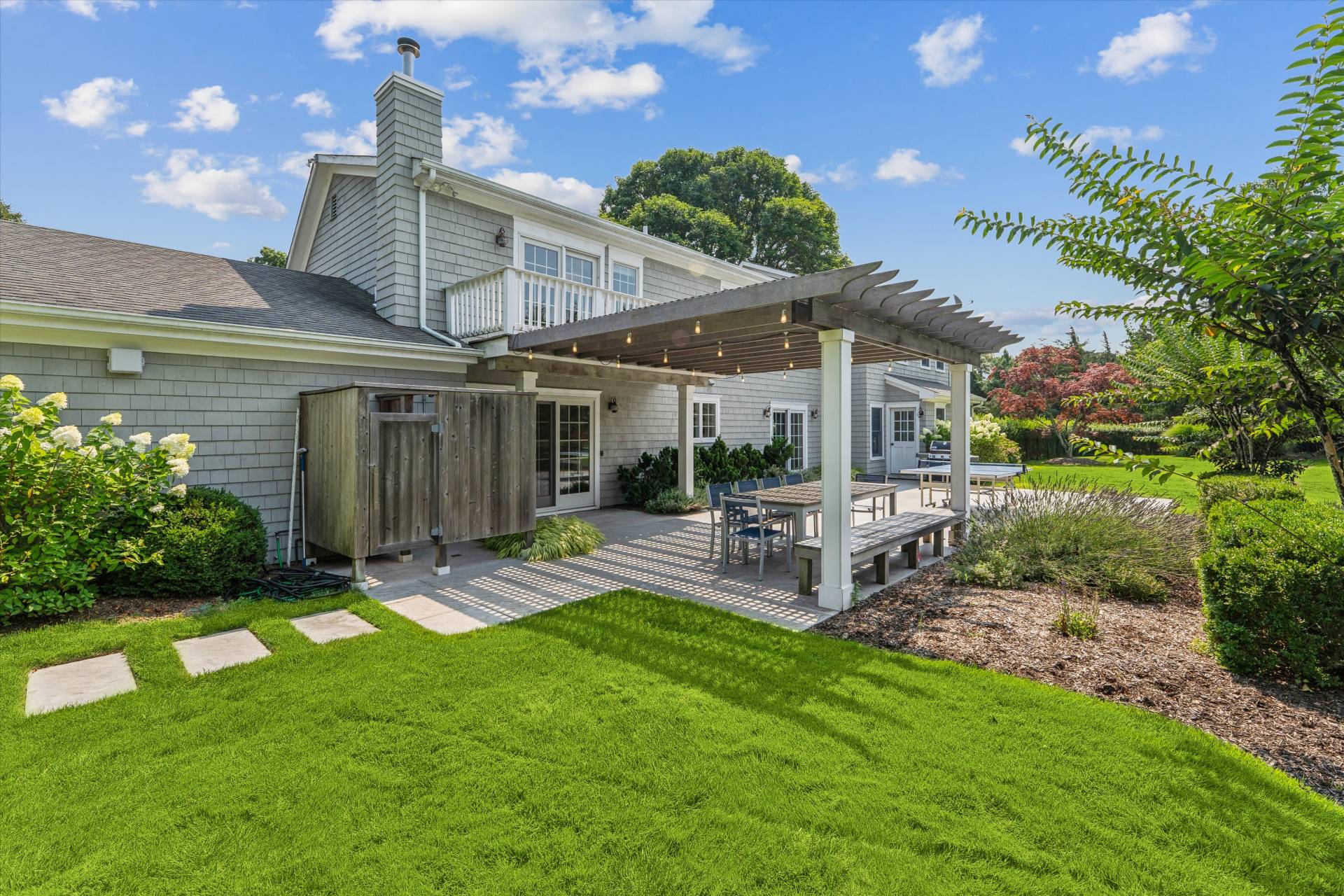 29 Bridle Path Remsenburg, NY 11960 - Photo 4 of 33 a front view of a house with garden and patio