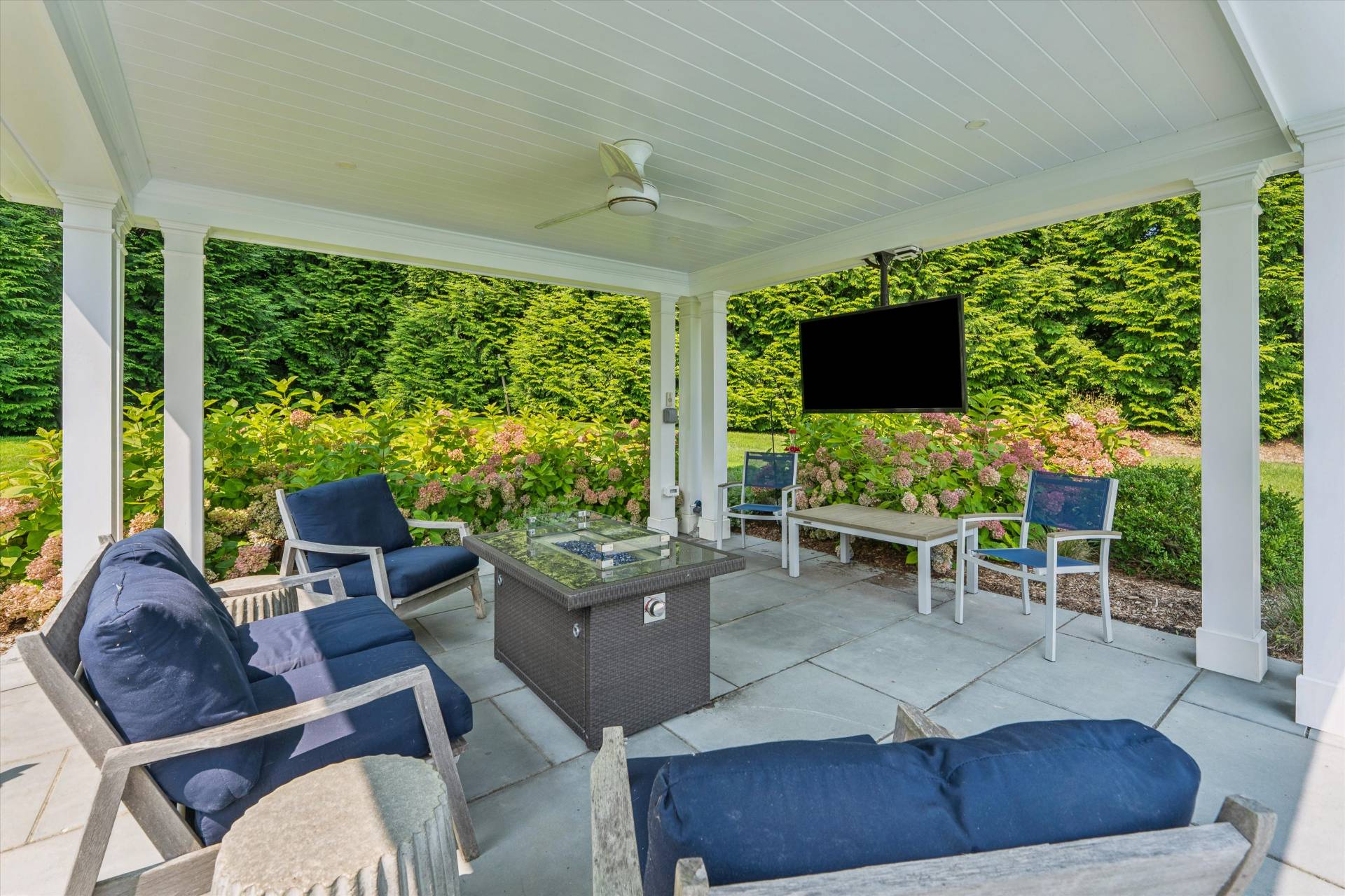 29 Bridle Path Remsenburg, NY 11960 - Photo 6 of 33 a living room with furniture a flat screen tv and floor to ceiling windows