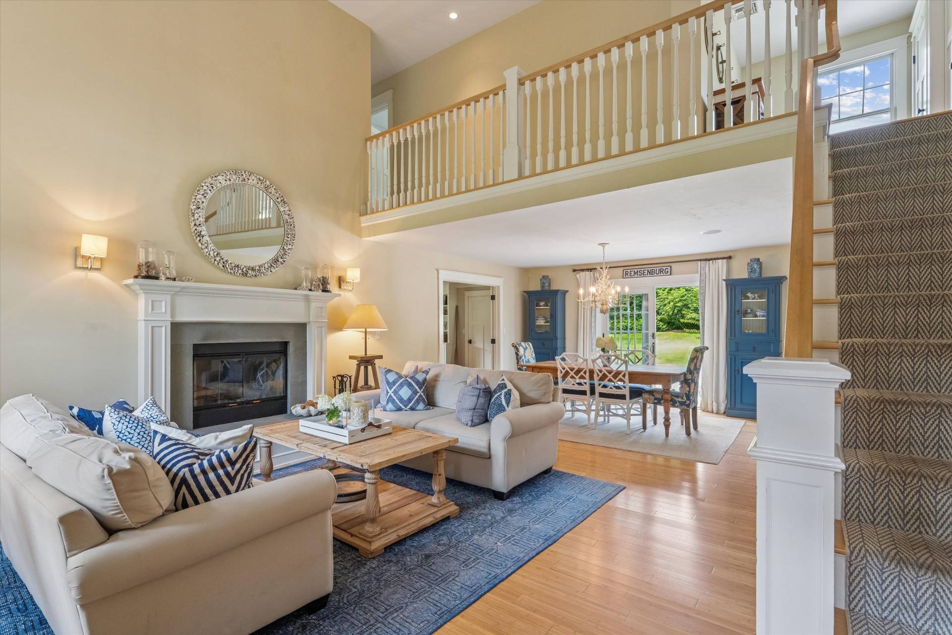 29 Bridle Path Remsenburg, NY 11960 - Photo 8 of 33 a living room with furniture a fireplace and a floor to ceiling window