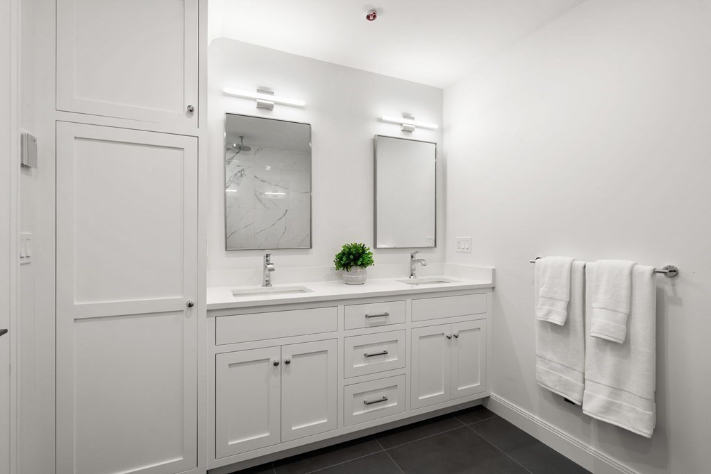 400 Hunnewell Street, Unit 103 Needham, MA 02494 - Photo 14 of 20 a bathroom with a double vanity sink and mirror