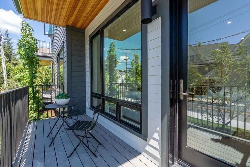 400 Hunnewell Street, Unit 103 Needham, MA 02494 - Photo 20 of 20 a view of a balcony with chairs and wooden floor