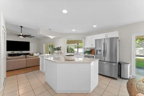 a view of a dining room with furniture and a kitchen
