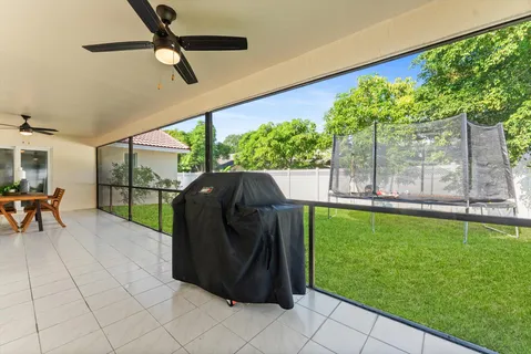 a bedroom with a bed a flat screen tv on dresser and a window
