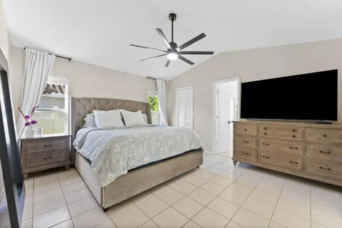 a bedroom with a bed and a flat screen tv