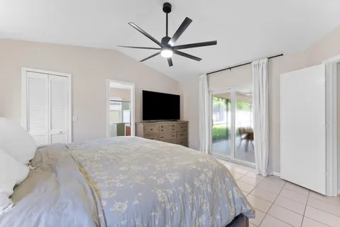 a bedroom with a large bed and a chandelier