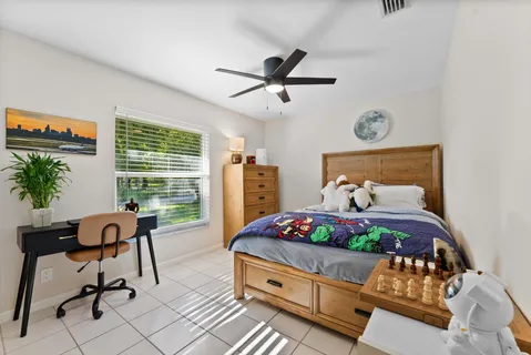 a bedroom with a bed and a desk