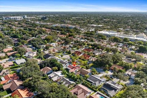 an aerial view of residential houses with city view