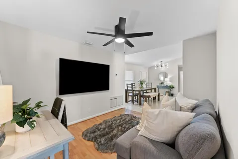 a living room with furniture and a flat screen tv