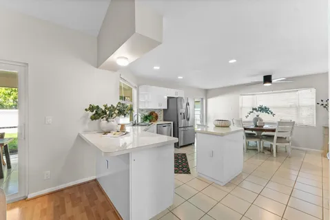 a kitchen with stainless steel appliances a sink and a refrigerator