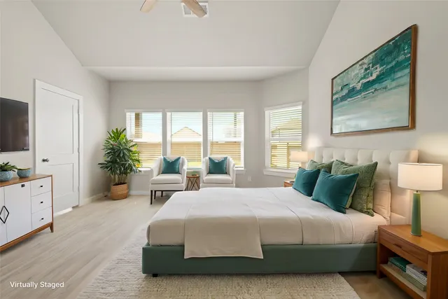 a bedroom with a large bed and a window