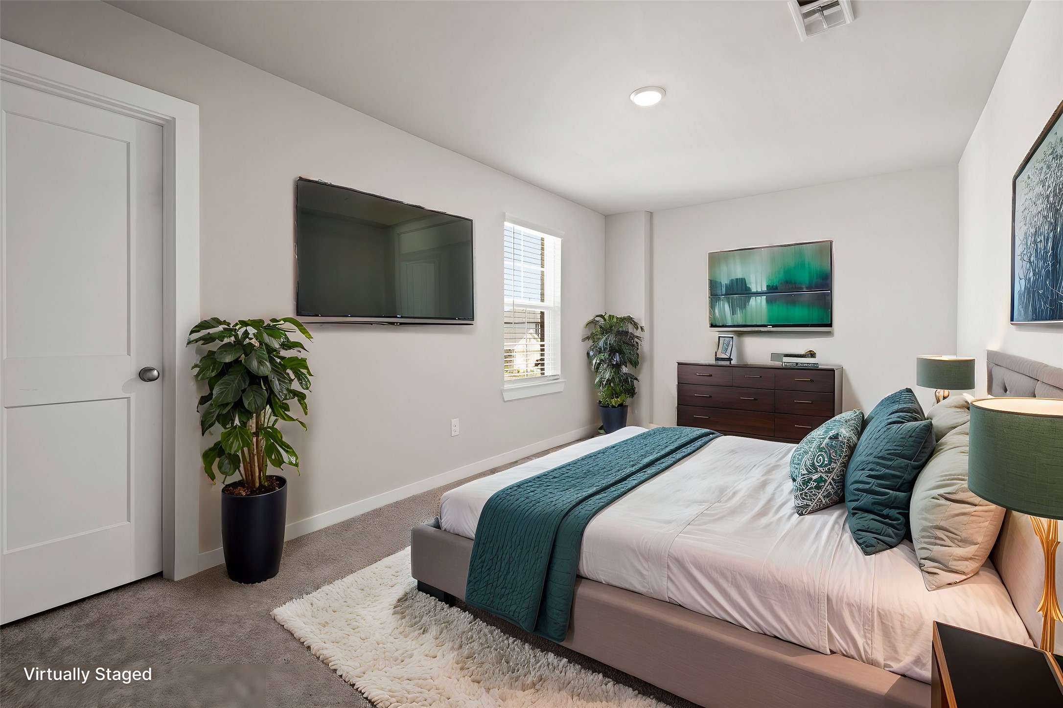 21667 Wave Holw Drive Cypress, TX 77433 - Photo 20 of 27 a bedroom with a bed table and a flat screen tv