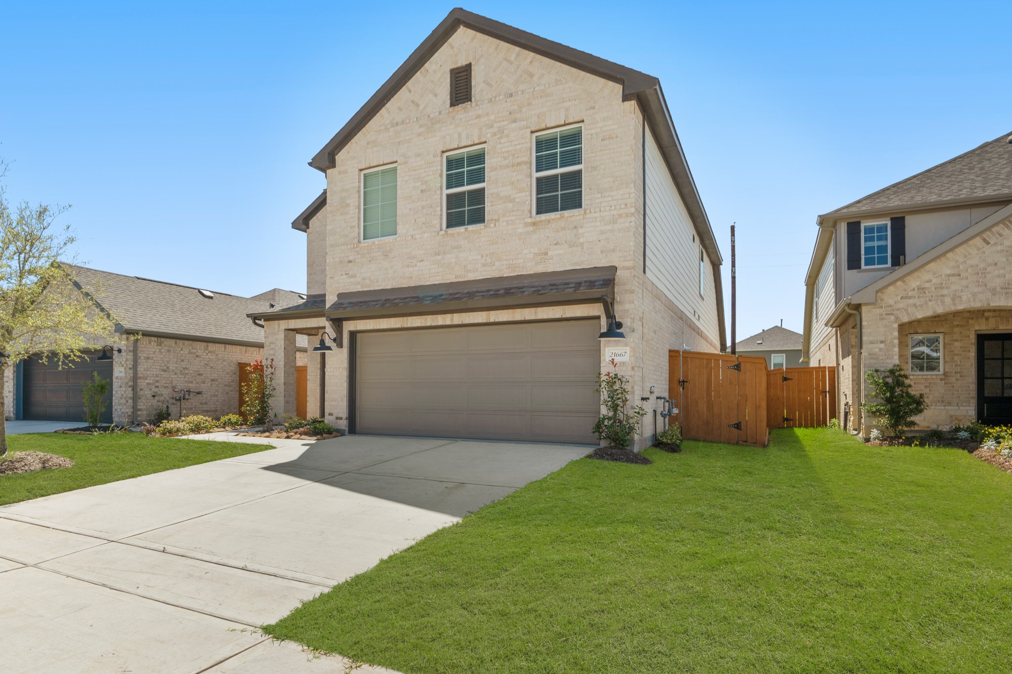 21667 Wave Holw Drive Cypress, TX 77433 - Photo 3 of 27 a front view of a house with a yard and garage