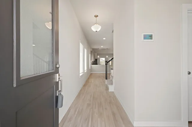 a view of a hallway with wooden floor