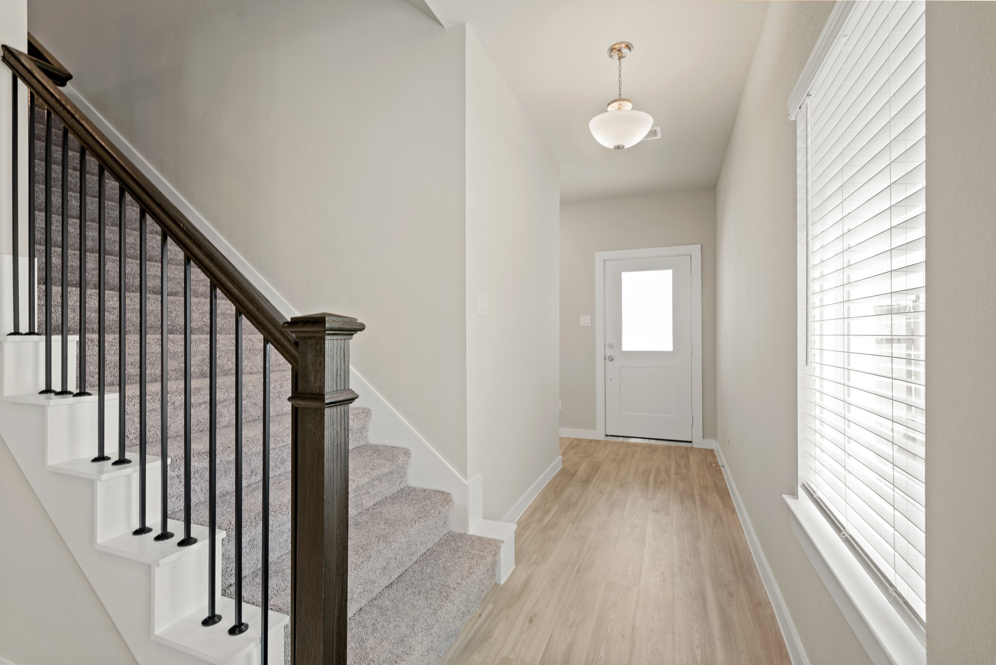 21667 Wave Holw Drive Cypress, TX 77433 - Photo 6 of 27 a view of a hallway view with wooden floor and staircase