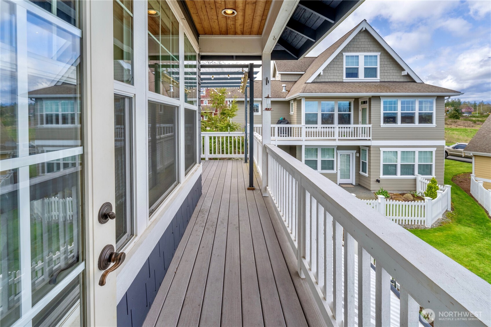 71 Craftsman Court Sequim, WA 98382 - Photo 14 of 33 a view of residential houses with wooden deck and floor to ceiling window