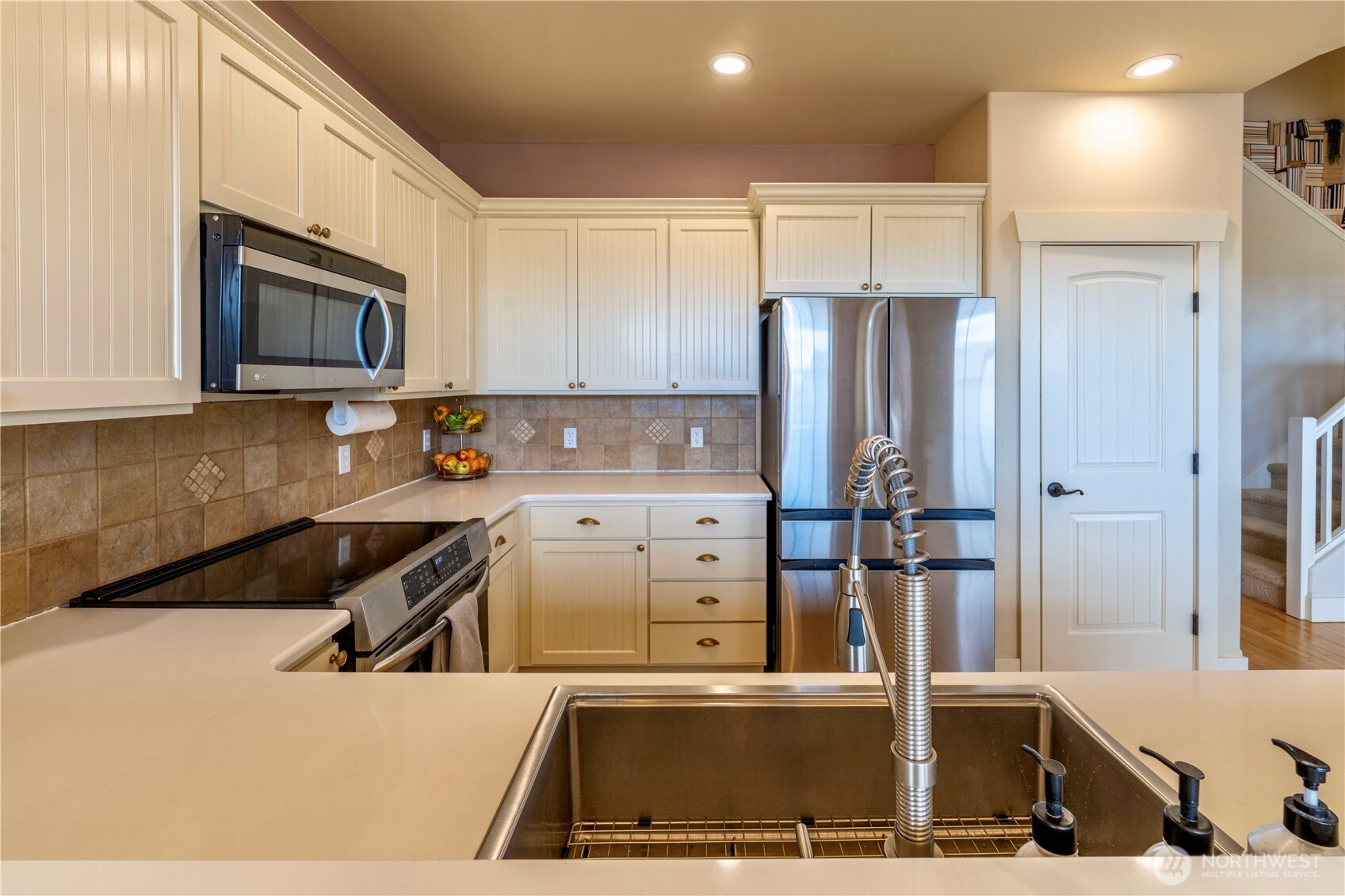 71 Craftsman Court Sequim, WA 98382 - Photo 9 of 33 a kitchen with stainless steel appliances granite countertop a refrigerator and a stove top oven