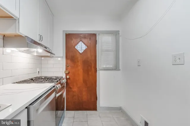 a kitchen with a stove and a refrigerator