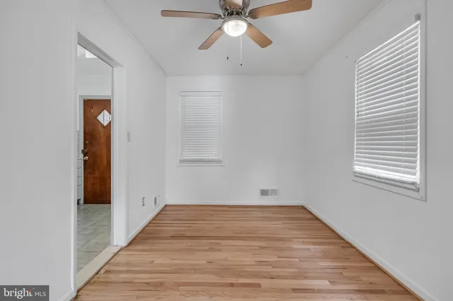 a view of empty room with wooden floor