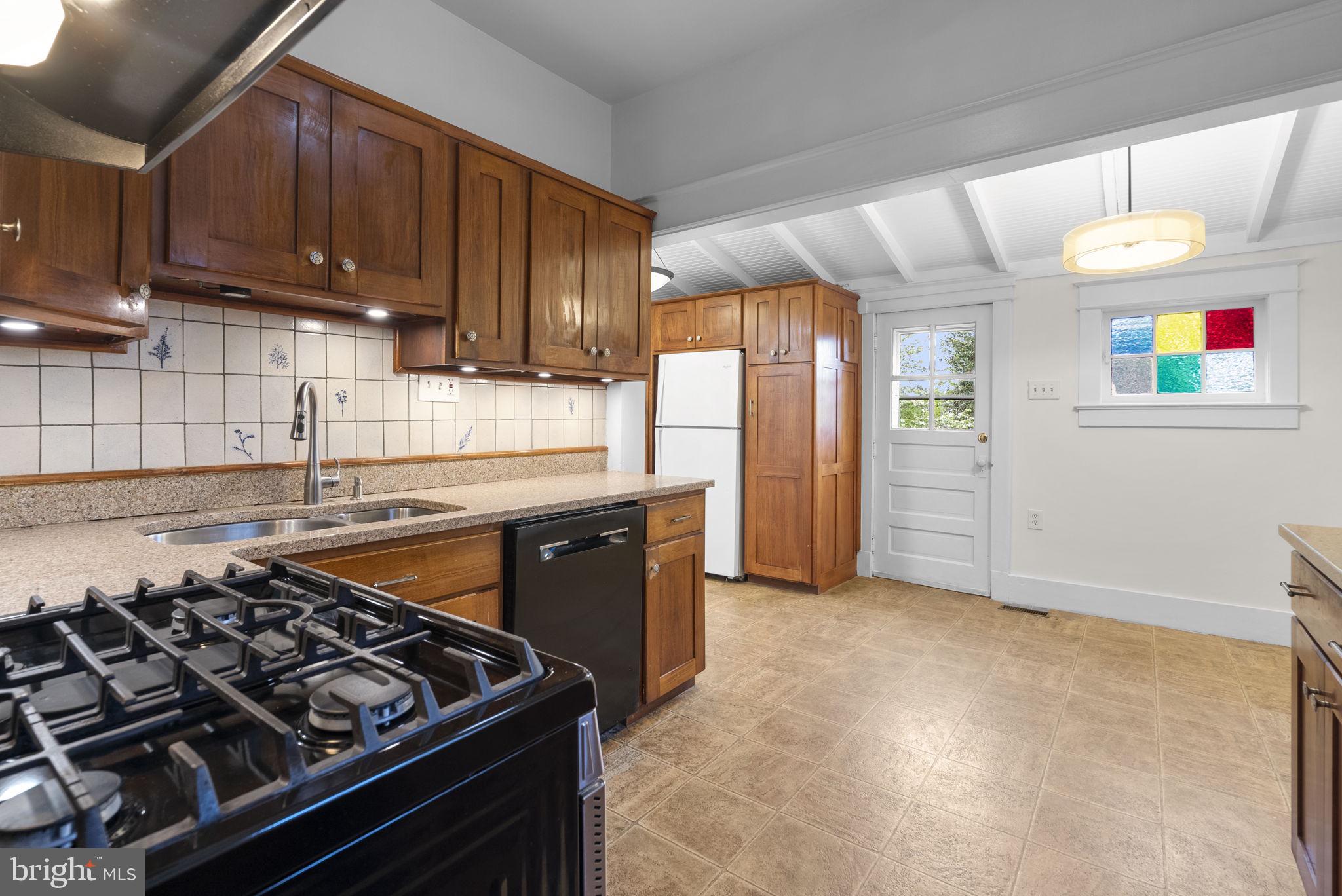 9120 Glenridge Road Silver Spring, MD 20910 - Photo 13 of 59 a kitchen with a stove and a refrigerator