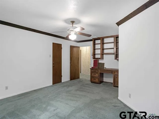 a view of a livingroom with a furniture and chandelier fan