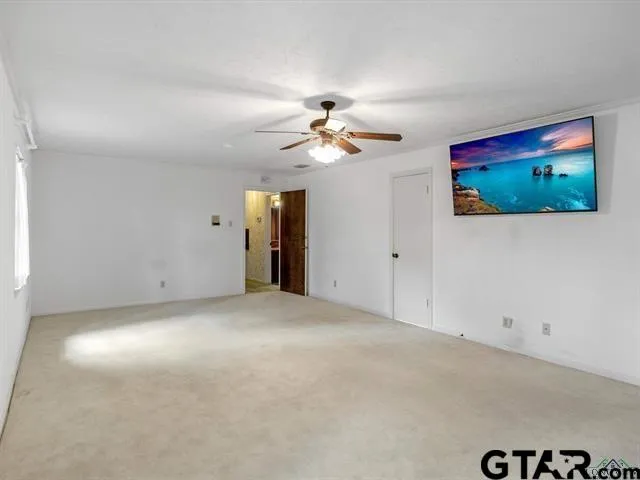 en empty room with fan and window