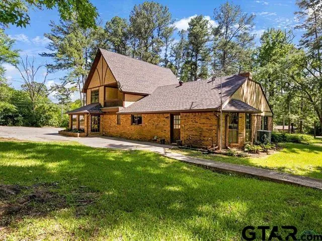 a front view of a house with yard and green space