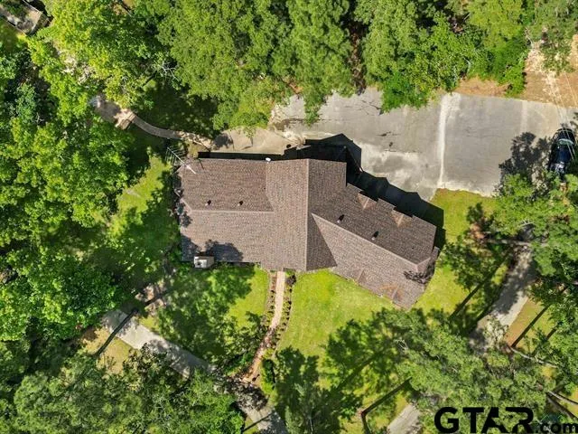 an aerial view of a house with a yard