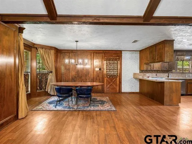 a view of a kitchen with kitchen island a counter top space a sink stainless steel appliances and cabinets
