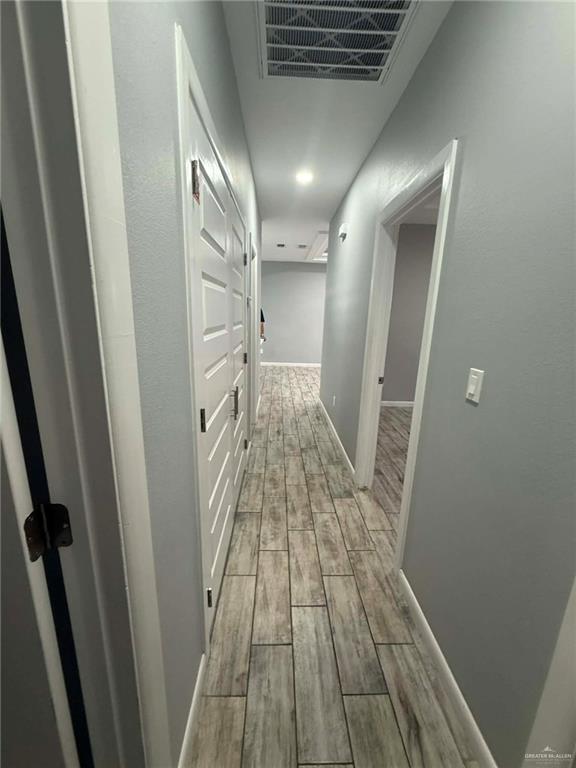 1316 South Xanthia Street, Unit 4 Mission, TX 78573 - Photo 12 of 17 a view of hallway with wooden floor