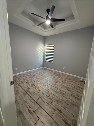 a view of a livingroom with a ceiling fan and window