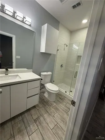 a bathroom with a glass door shower