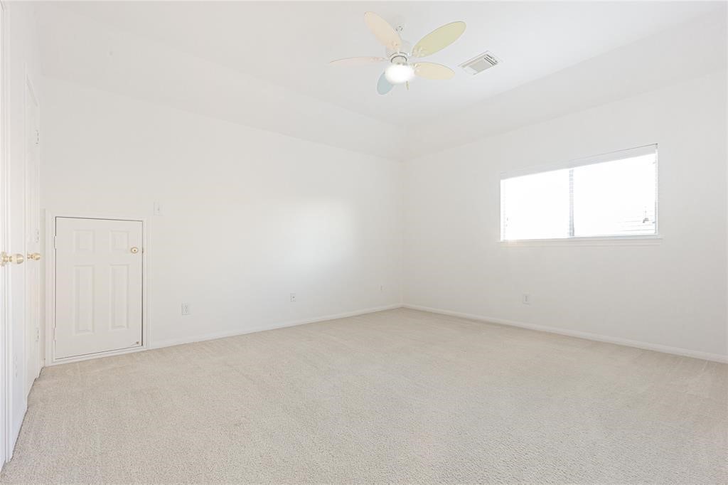 7635 Golden Thistle Lane Cypress, TX 77433 - Photo 14 of 15 an empty room with a window and a ceiling fan