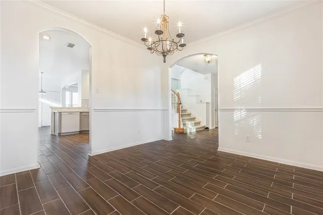 a view of a room with wooden floor and staircase