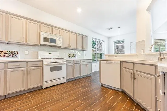 a kitchen with white cabinets sink and white appliances