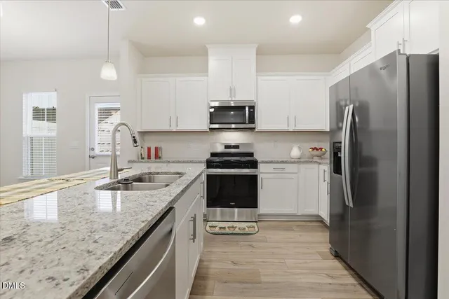 a bathroom with a sink toilet vanity tub and shower